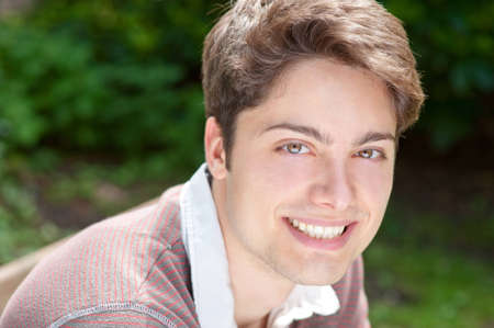 Young and smiling man in the park