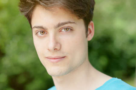 Young and smiling man in the park