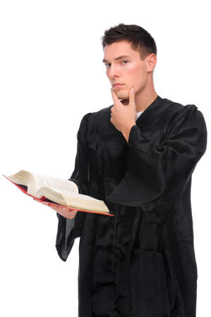 Full isolated studio picture from a young judge (lawyer) with statute bookの写真素材