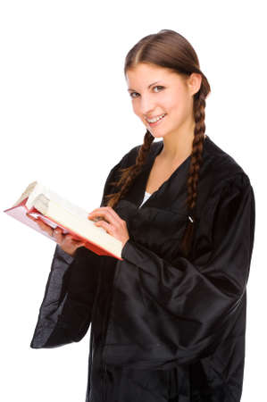 Full isolated studio picture from a young judge (lawyer) with statute bookの写真素材