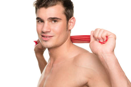 Man with gymnastic band in front of white backgroundの写真素材