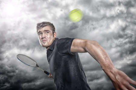 Tennis player in front of dramatic skyの写真素材