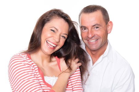 Smiling couple in front of white background の写真素材