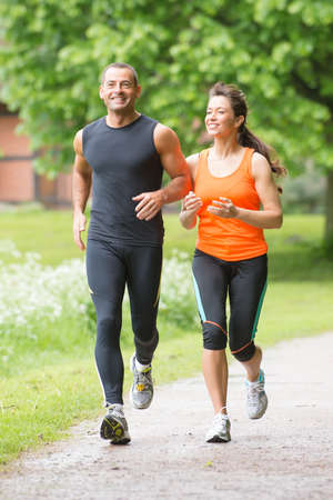 Sport couple running in parkの写真素材