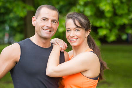 Sport couple in front of green forestの写真素材