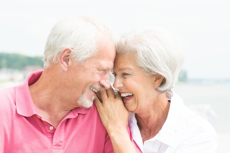 Happy and smiling senior couple at the beachの写真素材