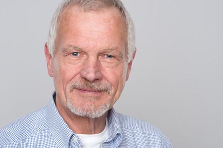 Senior man in front of grey background