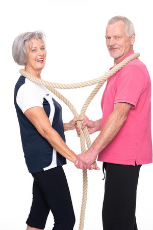 Active senior couple in front of white backgroundの写真素材