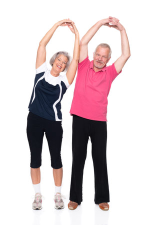 Active senior couple in front of white backgroundの写真素材