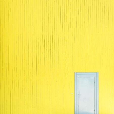 Yellow wall with doorの写真素材