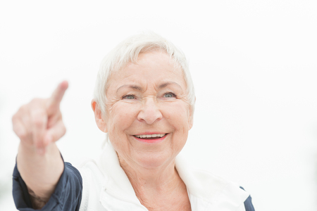 Smililing senior woman with grey hairの写真素材