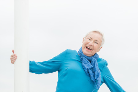 Smililing senior woman with grey hairの写真素材