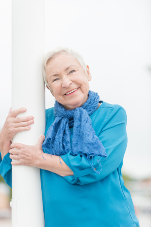 Smililing senior woman with grey hairの写真素材