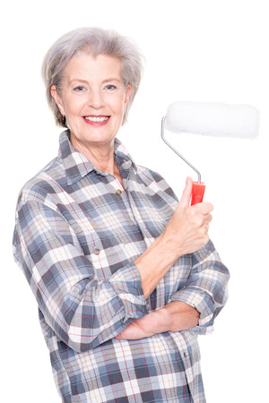 Senior woman as a painter in front of white backgroundの写真素材