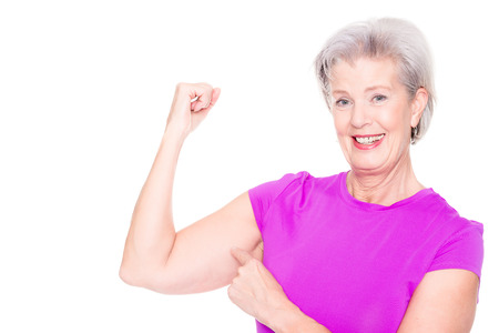 Active and sporty senior woman in front of white backgroundの写真素材