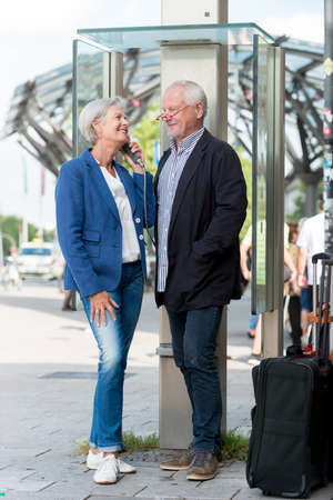 Senior couple call in a phone boxの写真素材