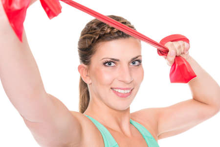 Young and sporty woman in front of white backgroundの写真素材