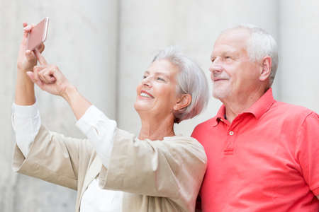 Smiling senior couple make a selfieの写真素材