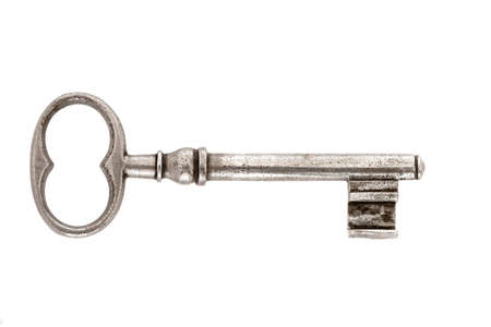 Old key in front of white backgroundの写真素材