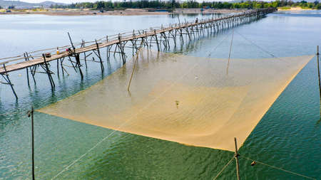 Yellow fishing net on the river central Vietnamの写真素材