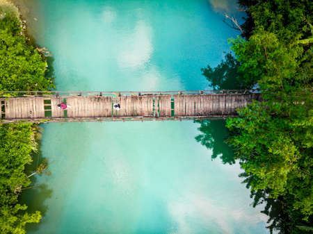 Nice wooden bridge across the green lake in Moc Chau province northern Vietnamの写真素材