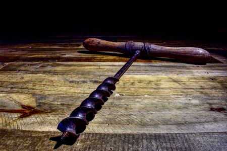 Old fashioned drill on a wooden backgroundの写真素材