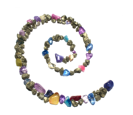 a spiral of gold shiny rocks and gems, forming a symbol. The picture is reflective of color, texture, symbols, separated, whiteの写真素材