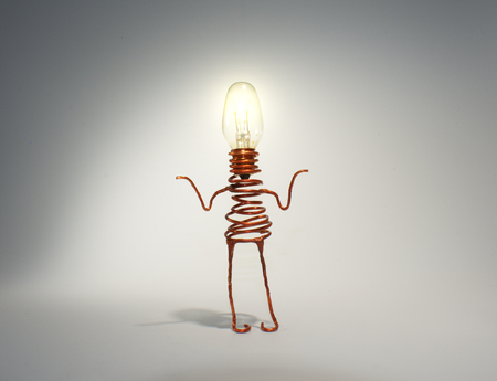 A quirky light globe robot with an illuminated head shrugs. The picture is reflective of quirkiness,...