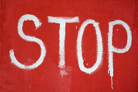 hand writed Stop sign on red wallの写真素材