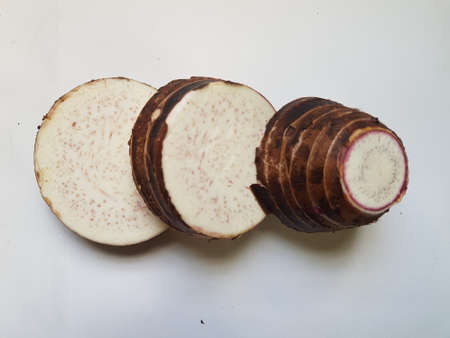 Taro slices and cube was cuted for cooking new dishes  on white and wood background.