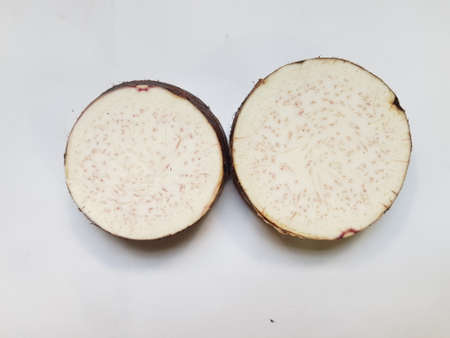 Taro slices and cube was cuted for cooking new dishes  on white and wood background.