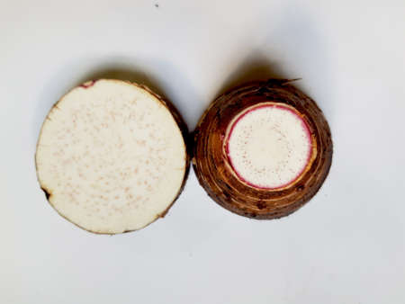 Taro slices and cube was cuted for cooking new dishes  on white and wood background.