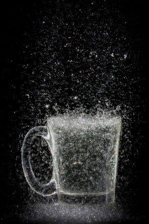 water splash in glass on black backgroundの写真素材