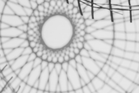 abstract background of shadows Bamboo basketry on a white wall.の写真素材