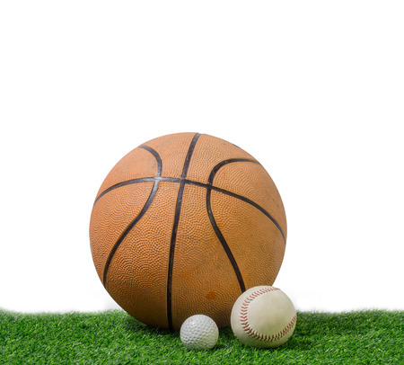 golf ball, baseball and basketball in green grass on white background.の写真素材