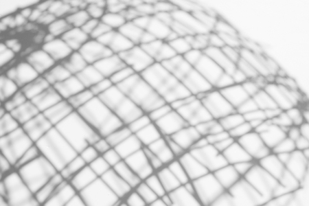 abstract background of shadows Bamboo basketry on a white wall.の写真素材