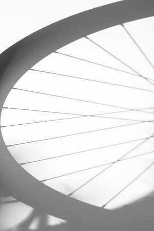 shadows of bicycle wheel on white backgroundの写真素材