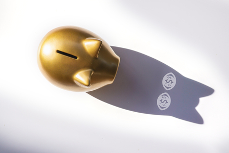 Top view gold piggy bank on white background with shadows in the eyes is money icon. concept savingsの写真素材