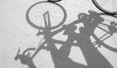 shadow of bike on surface road background, black and white toneの写真素材