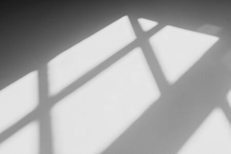 abstract shadow of the window in morning light on white wall texture backgroundの写真素材