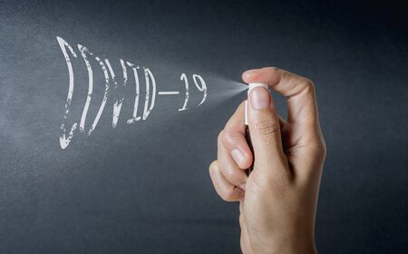 Hand holding 70% alcohol small spray bottle and spraying sterilize Covid-19. concept prevent disease Covid-19.の写真素材