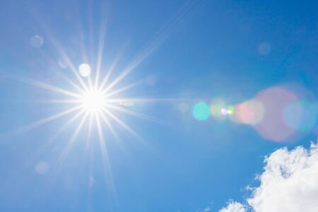 sun on blue sky with sunbeams and flare light in the day
