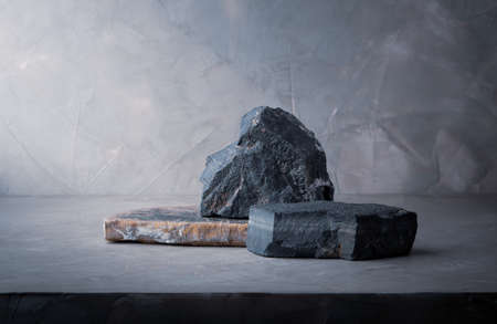 dark stone podium stage, stone composition for show product packaging and cosmetic on gray concrete wall background, copy spaceの写真素材