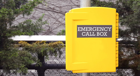 Yellow emergency call box in New York for assistance in case of an emergency.