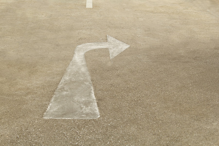 A way arrow symbol on asphalt road surface.