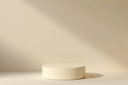 A round, cream-colored pedestal sits against a soft beige backdrop, illuminated by gentle light, perfect for product presentations or artistic displays. The calming environment enhances focus.の素材