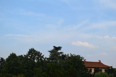 Chinese ancient architecture and green forest with blue sky in Beijing, Chinaの写真素材