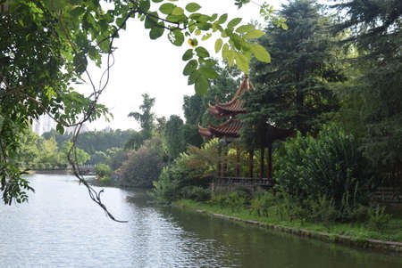 View of a lake and a pavilion in a park in Chinaの写真素材