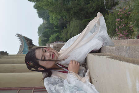 Girl lying on the stairsの写真素材