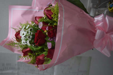 Bouquet of red roses in pink paperの写真素材